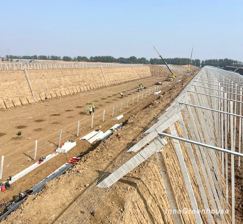 Earth wall solar greenhouse construction site